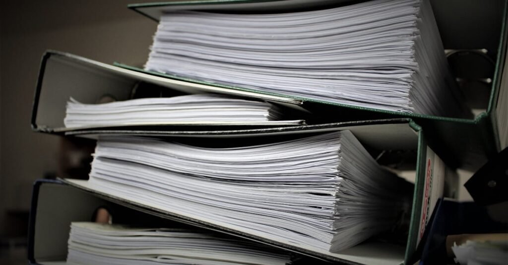 Close-up of stacked binders filled with documents for office or educational use.